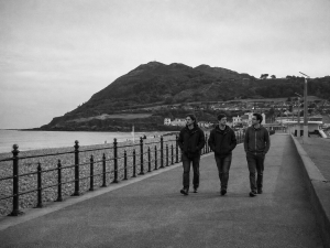 Jesse Rómlárson, Eoin Belfield and Nevan Lochlann walking along Bray Promenade in Dublin during the early years of Eventstellar in 2016