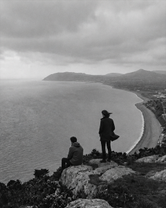 Black and white photograph of Eoin Belfield and Nevan Lochlann overlooking Killiney Bay in Ireland in 2017