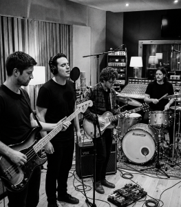 Black and white photograph of Eventstellar members Nevan Lochlann, Eoin Belfield, Jesse Rómlárson and Jon Gilmour recording together in a Reykjavík recording studio, Iceland during the band's early recording sessions in 2017