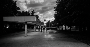 Black and white photograph of the four members of Eventstellar walking through the University College Dublin campus at dusk in 2017