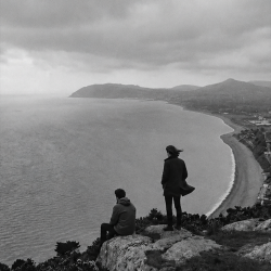 Black and white photograph of Eoin Belfield and Nevan Lochlann overlooking Killiney Bay in Ireland in 2017