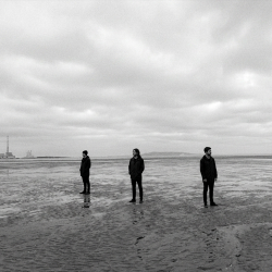 Jesse Rómlárson, Eoin Belfield and Nevan Lochlann at Sandymount Strand in Dublin during the early years of Eventstellar in 2016