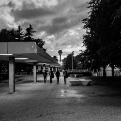 Black and white photograph of the four members of Eventstellar walking through the University College Dublin campus at dusk in 2017