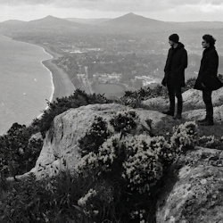 Black and white photograph of Jesse Rómlárson and J.J. Gilmour overlooking Killiney Bay in Ireland in 2017
