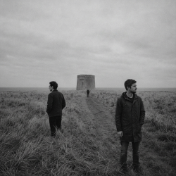 Jesse Rómlárson, Eoin Belfield and Nevan Lochlann near a Martello tower in Dublin during the early years of Eventstellar in 2016