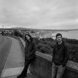 Nevan and Eoin overlooking Bray Bay during an overcast afternoon in Bray, Ireland