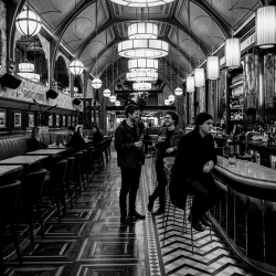 Black and white photograph of Jesse Rómlárson, Eoin Belfield and J.J. Gilmour inside Café en Seine in Dublin, Ireland during the early Eventstellar years in 2017