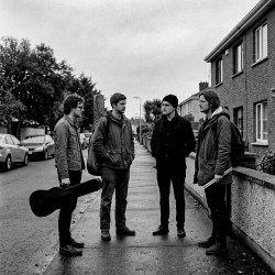 The four members of the emerging Eventstellar lineup talking outside a house in Bray before an early rehearsal