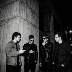 Black and white photograph of Jesse Rómlárson, Eoin Belfield, Nevan Lochlann and J.J. Gilmour outside University College Dublin after an early Eventstellar performance in 2017